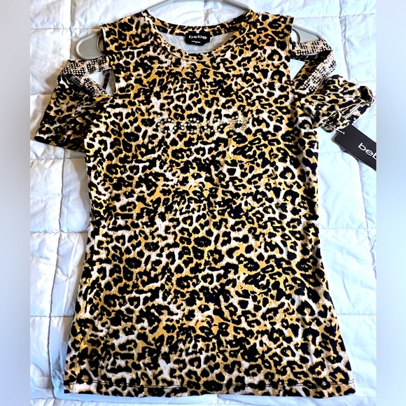 bebe Tops - NWT Bebe fitted cut out shoulder crew neck top. Women’s S. Rhinestone design